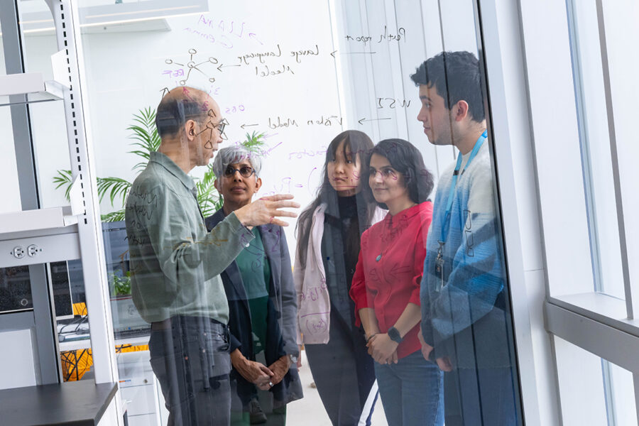 Drs. Anita Palepu and Raymond Ng speak with students.